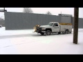 Snow plow truck cleaning streets.
