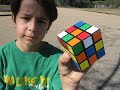 Child solves Rubiks Cube while skateboarding (ripstiking)