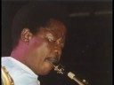 i don't have any pictures of isaac musekiwa speaking, so here is one of him playing alto sax (1989), which he has done from the early 1960's untill his death, within months after franco died. before that, in the 1950's, isaac played tenor sax with african jazz and o.k. jazz. here, isaac (zimbabwian) does the introduction in english. vocals, besides isaac and franco: youlou mabiala and lola ch�cain. franco would rework this tune in the late 1970's when he incorporated it into oh! miguel. miguel, like m'poto, stands for europe. foto isaac: johan vd krogt. als je dit ziet johan, neem alstjeblieft contact met me op. (jij kent me onder mijn echte naam) dus registreren & mailen. ajb.