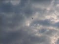 Moving clouds in the skies, a plane flies by, dark clouds move in, love is future - stop the war; film by filmer j, music by mona bardos and klinger j