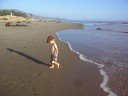 Toddler playing in the waves at the beach