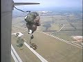 world war ii reenactors jumping from a wwii-vintage c-47 in authentic uniforms.