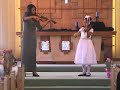 Justine at Age 9.  Performing Bach Double Concerto at a recital with her mom.