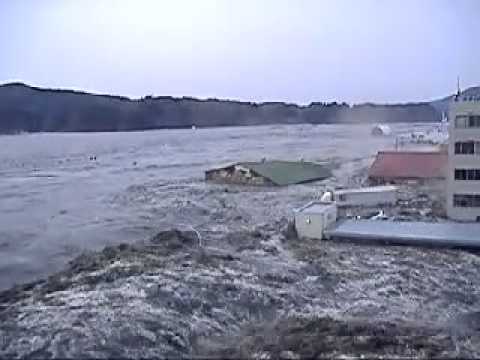 japan earthquake 2011 - Japan tsunami ravaging the city of Kesennuma, in the northeastern part of the country. a wall of water breaches the coastline and starts sweeping away a park...