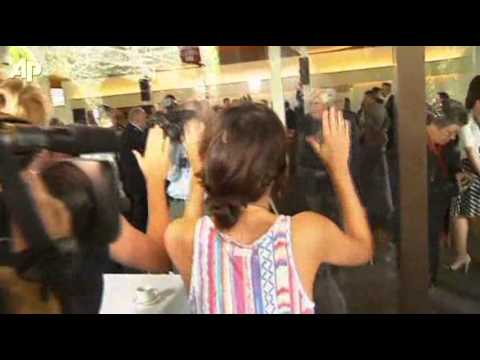 Loses shoe in scuffle with activists.