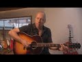 Ma rk Knopfler Showing his magic on an acoustic guitar