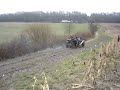 Vintage Bentley drives on muddy field