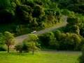 car drives down a hill