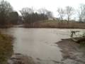 at 2:45 p.m. tuesday, ben williams road was still open to traffic despite torrential currents running across it.