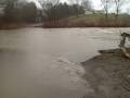 at 2:45 p.m. tuesday, ben williams road was still open to traffic despite torrential currents running across it.