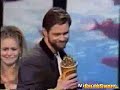 alicia silverstone presenting award to jim carrey. kisses her onstage