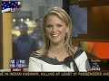 Newswoman bending over in a black leather skirt