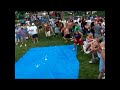 Large man almost loses shorts after going down water slide. Large man almost loses shorts after going down water slide.