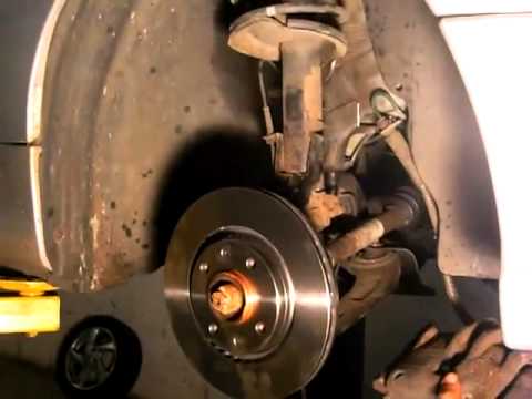 Changing the brake discs and brake pads on Peugeot 206 by an African Female Mechanic
