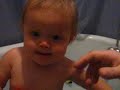 Babbling in bathtub with an oragne