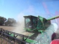 John Deere 9510 Maximizer combine unloading on the go (grain cart view)