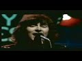 the performance of al stewart: the year of the cat, it's from the uk tv show the old grey whistle test, in 1976.

al stewart - the year of the cat (1976)
on a morning from a bogart movie
in a country where they turn back time
you go strolling through the crowd like peter lorre
contemplating a crime
she comes out of the sun in a silk dress running
like a watercolour in the rain
don't bother asking for explanations
she'll just tell you that she came
in the year of the cat.

she doesn't give you time for questions
as she locks up your arm in hers
and you follow 'till your sense of which direction
completely disappears
by the blue tiled walls near the market stalls
there's a hidden door she leads you to
these days, she says, i feel my life
just like a river running through
the year of the cat

she looks at you so cooly
and her eyes shine like the moon in the sea
she comes in incense and patchouli
so you take her, to find what's waiting inside
the year of the cat.

well morning comes and you're still with her
and the bus and the tourists are gone
and you've thrown away the choice and lost your ticket
so you have to stay on
but the drum-beat strains of the night remain
in the rhythm of the new-born day
you know sometime you're bound to leave her
but for now you're going to stay
in the year of the cat.