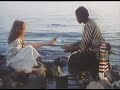 Marion Dia in white dress on beach