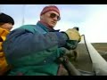 Travel program host wearing yellow North Face Baltoro jacket