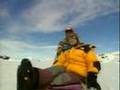 Travel program host wearing yellow North Face Baltoro jacket
