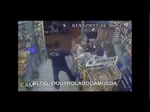 shoot out - Off Duty Cop in a blue shirt. My analysis of the video looks like the two guys in white shirts were acting as look out for the robbers.The fat guy kept on lo...
