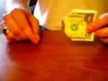 Folding a dollar bill into a bow tie