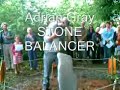 an excellent demonstration by adrian grey, stone balancer, at the sculpture garden event in lyme regis.