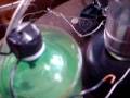 The detonation of HHO Gas launches a Nickle placed over the one way valve. This is just another video of my ongoing attempts to construct a device to generate, collect and detonation HHO gas; with the ultimate goal of running an engine off of the stuff. The detonation is achieved by the use of a Van De Graff generator to charge up a Leyden Jar, and then a system of two spark gaps, one inside the Chamber ( Fixed gap inside soda Bottle) and the other which is adjustable is between the Leyden jar and the detonation chamber. When it works, which so far has been rare, it runs automated and detonates the Gas at fairly frequent periods. When for what every reason the Leyden jar fails to fire, the build up of Gas usually results in various stages of catastrophic chaos when it does detonate. :)