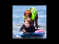 Surf Dog Ricochet surfs with brain injured 6 year old