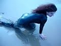 A DAY AT THE BEACH IN \"VINYL-CATSUIT AND HIGH HEELS\"