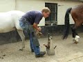 After 2 months, the fear for a farrier is still very there. Little doubt, that severe abuse and extreme forced handling must be the reason.For myself, picking up and cleaning all his feet and hammering on an iron on his front feet is no longer a problem.Already the noises of the farrier, the sound of the gasoven for heating up the irons etc. made it difficult to get him out of his safe stable. With good words and a carrot, I managed :).A very helpfull young, but quiet and experienced farrier, and a 23 year old pony come in handy.So just tying him to the wall, and let him experience the farrier without bad things happening to himself, might prove the best cure in the end.