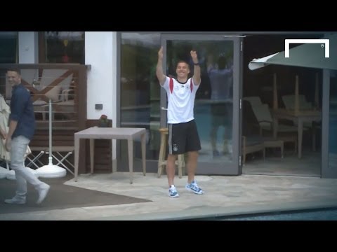 Video: Podolski throws journalist into pool