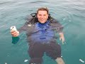 Diver has a beer after last dive of day Diver has a beer after last dive of day