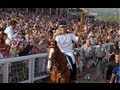 Zara Phillips carries London 2012 Olympic torch on horseback through Cheltenham racecourse