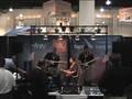 The guys from Bose play Rock Band at JBL booth for Best Buy