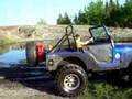 9 year old driving a 1979 Jeep CJ-5 in mud