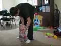 Adrion laughing, but this time his daddy is playing with him