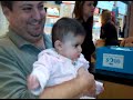 Baby getting ears pierced, Dad crying.