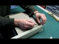 Attaching binding cloth to the small tray and covering the open ends of the tray.