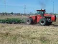case ih 9180 unfolding a 42' great plains field finisher to begin tilling a field.