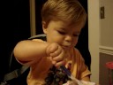 Isaac feeding himself yogurt
