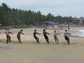 Fishermen pulling in the nets, Kovalam