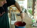 SIMON LEACH - Dipping bottle vases in red ironslip.