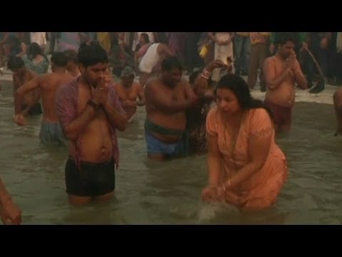 bathing in ganga - Millions of Hindus are arriving at Allahabad to bathe in the Ganges river for the Maha Kumbh Mela, billed as the world's largest religious festival. Near a m...