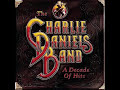 the charlie daniels band preforming uneasy rider 88'

lyrics:
me and my buddy got us a wild hair
and figured we wanted to go somewhere
so we loaded up in my ragtop chevrolet
we had a little bit of money
and a whole lot of show
adn with hank jr. blaring on the radio
we got us a tank full of gas
and we was on our way

we figured we'd go down to new orleans
we were barrelling down old 17
when a man with a blinking red light
was on our tail
he said you were doing 60 in a 45
but i'm gonna let you go this time
but if i catch you again
i'm gonna slap you in the county jail

we said thank you sir you sure been nice
and you ain't gonna have to tell us twice
and we were southbound and down with the wind
blowing in our faces
we kept on rolling and pretty soon
the radio was cooking out a haggard tune
and we were pulling into houston
checking out all them places

i was feeling dry and i said i think
we ought to stop and get ourselves a drink
and old jim said yeah 'cause we got time to kill
we kept on rolling and i seen this spot
and we pulled into the parking lot
of this place called the cloud nine bar and grill


we walked through the door
and the place was jammed
the lights were low they had a punk rock band
and some orange haired feller singing about suicide
i said jim this ain't our kind of place
he said well let's just have one round anyway
so against my better judgement we walked on inside
went up to the bar and we sat down
this feller walked up and said i'll buy this round
and he sat down on the barstool next to jim

he looked like a girl but he talked like a guy
he had lipstick on and mascara in his eyes
and everybody in that place looked just about like him
i said jim this ain't our kind of bar
let's just go on out and get back in the car
'cause there's gonna be trouble
ain't no sense in taking a chance
we was getting up getting ready to leave
when somebody grabbed old jim by the sleeve
and this good looking girl was asking my buddy to dance

i said jim don't do it there's something missing
there's fellers dancing and fellers kissing
there's a feller in high heeled shoes wearing panty hose
he said partner i just can't turn this down
you just go over there and have one more round
and i'll dance with the lady
and we'll get on down the road

so he walked away and left me alone
but this funny looking feller kept coming on
and he was making me mad with some of the things he said
then he put his hand on my knee
i said if you don't get your paw off me
i'm gonna locate your nose around
the other side of your head

he said i love it when you get that fire in your eye
i said well partner try this on for size
and i unloaded on him and he went out like a light
everybody in that place must have been his friend
they all headed for me i said this is the end
but where i come from we don't give up
without a fight

they were screaming and yelling and scratching and clawing
i was punching and hitting and kicking and pawing
i was holding my own 'cause i've been in a scrap or two
old jim come running up out of the blue
and that gal he was with come running up too
and proceeded to beat on me with a high heel shoe

i grabbed her by the hair it came off in my hand
and that beautiful girl was just a beautiful man
and old jim just got sick right there on the floor

he dropped that dude like a shot from a gun
smeared his lipstick made his makeup run
and me and old jim started fighting our way to the door

we lit out of there in that chevrolet
i put in on the floor and it stayed that way
we were going down the highway
doing about a hundred and ten
we were headed for home and we was getting nearer
then a red light came on the rear view mirror
and that same blame cop was pulling us over again

now i'm sitting here in this county jail
i had to call my daddy to go our bail
but i learned me a lesson
that i never will forget again
i've done give up drinking i've give up bars
and running around the country in souped up cars
i'm going back where the women are women
and the men are men