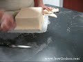In order to achieve a good finish you need to cover the cake with ganache first, allow it to set and ensure your fondant is rolled out fairly thin. Once you've done what's shown on the video, you will need to do further smoothing. ... 