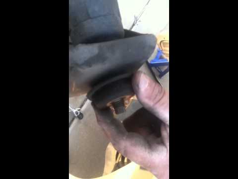 How to remove a rear shock absorber from a 2005 Kia Sedona