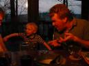Father Keeg blessing cherub at dinner