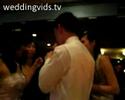 Couple shares tootsie pop at wedding with kiss. Couple shares tootsie pop at wedding with kiss.