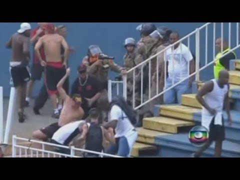 Violent - Subscribe to ITN News: http://bit.ly/itnytsub Violent clashes between Brazilian football fans caused a game to be suspended for more than an hour on Sunday. ...